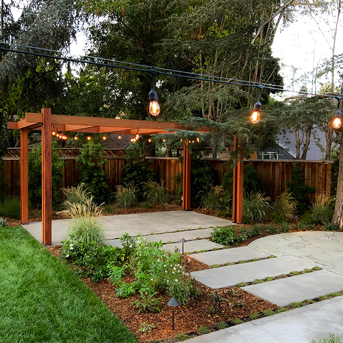 Beautiful redwood trell;is, garden and concrete paths.